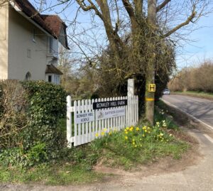 Photo shows white picket fence at the entrance to Saffron Grange vineyard