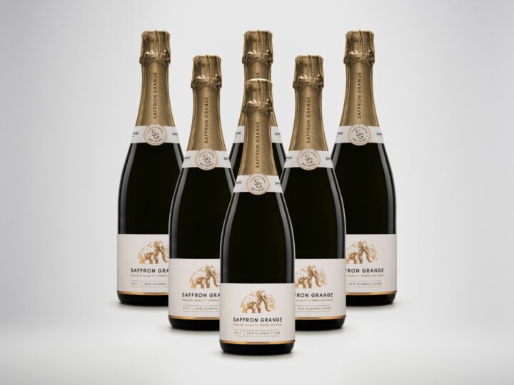 Image shows 6 bottles of sparkling wine lined up