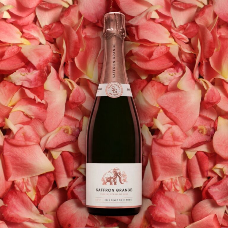 Image shows a bottle of the rosé lying on a bed of pink rose petals